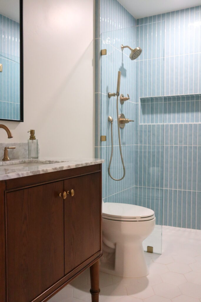 Full bathroom remodel in Camarillo, CA featuring Edward Martin Maisie Ocean tile, Reagan Dove hexagon flooring, and a Collette Cinnamon Oak vanity by All Pro Construction, Inc